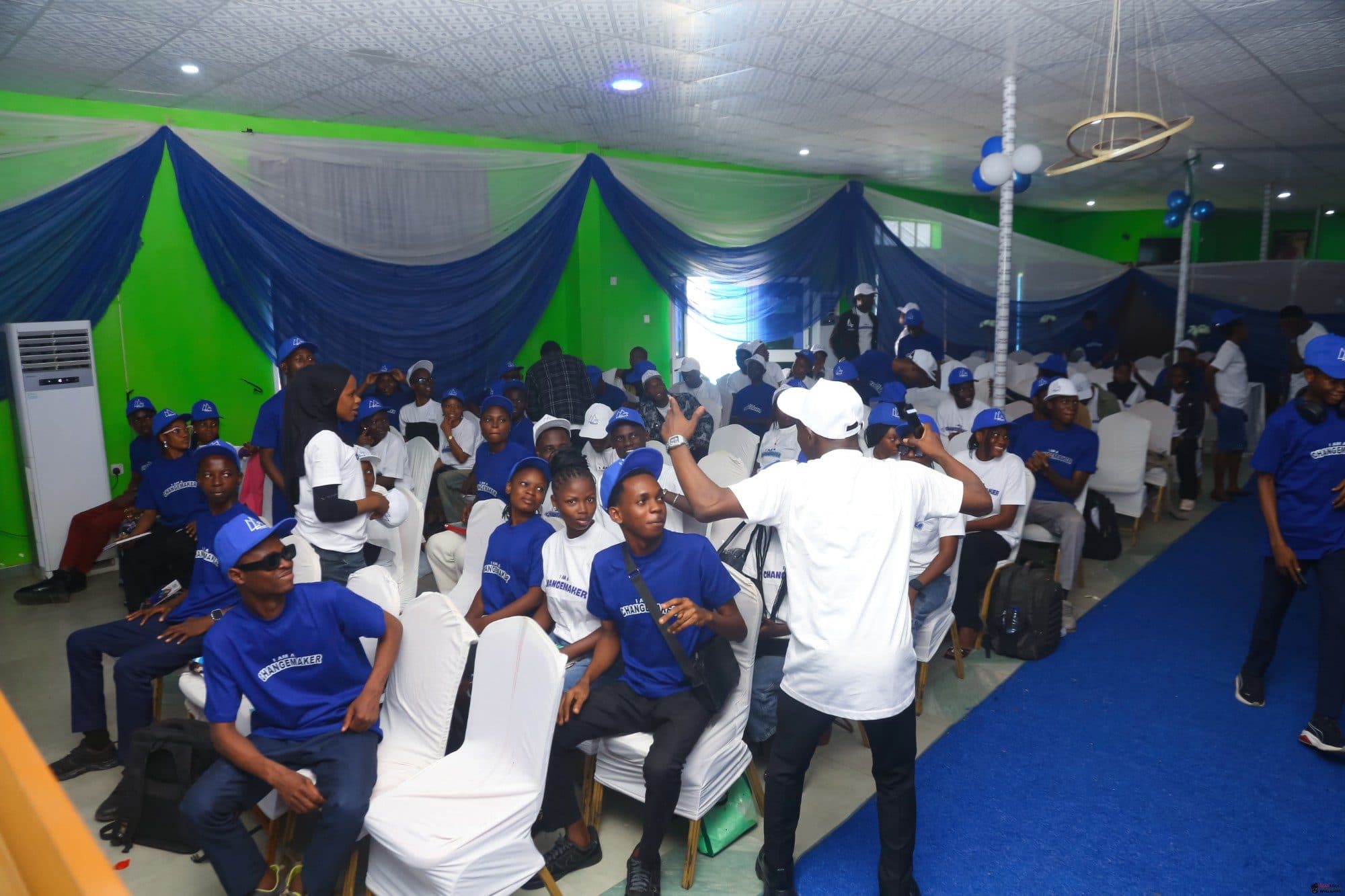 Members in Changemaker T-shirts cheering during a session